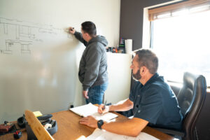 coworkers brainstorming at whiteboard