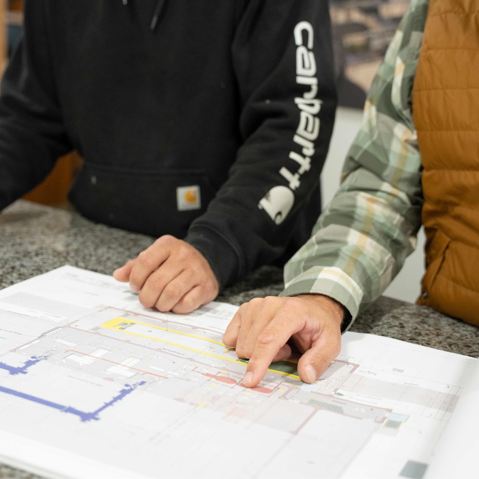 McCormick employees discussing blueprints