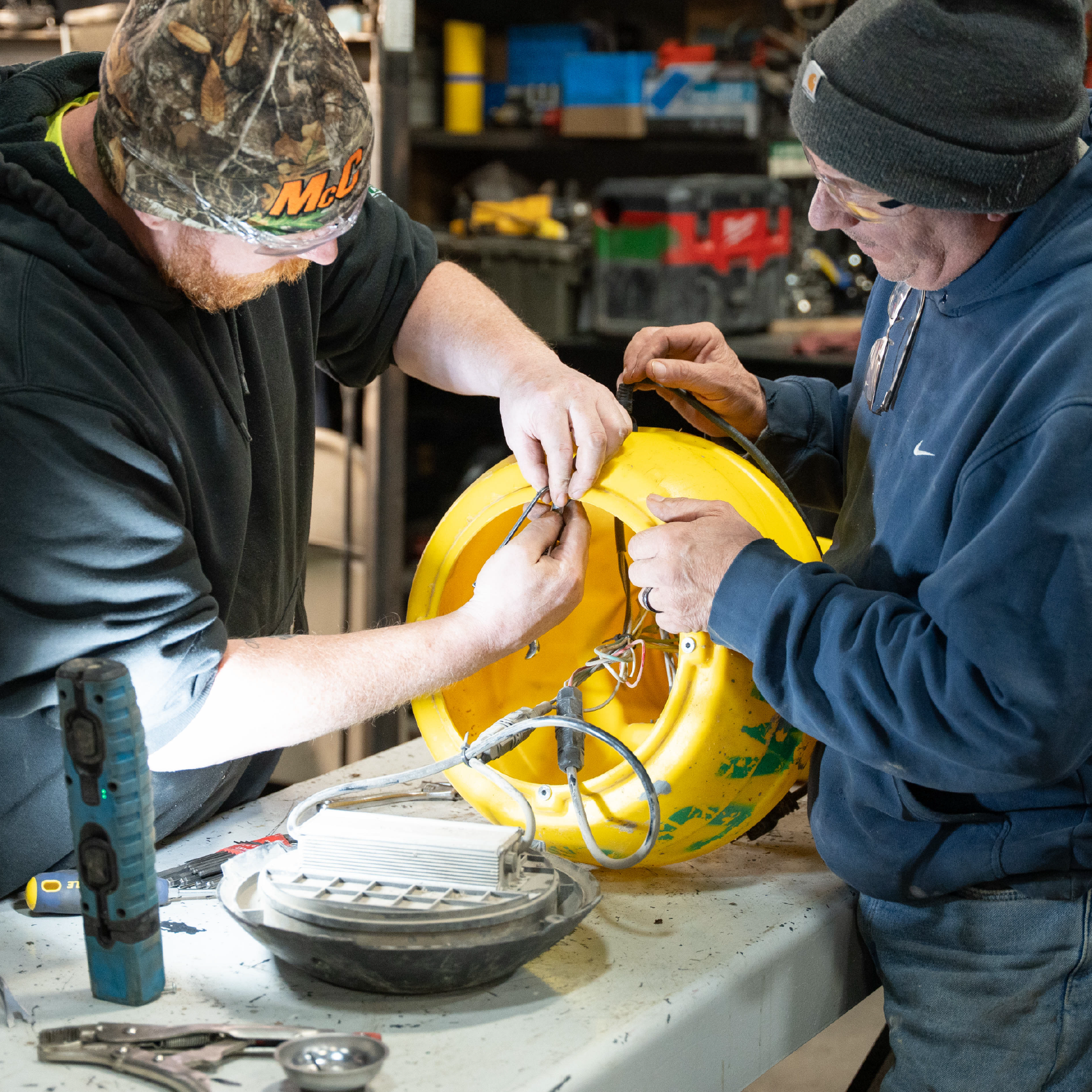 Two McCormick employees working on repair work in the shop